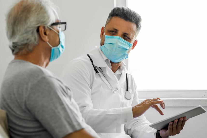 A photo of a doctor and patient talking about antibiotics